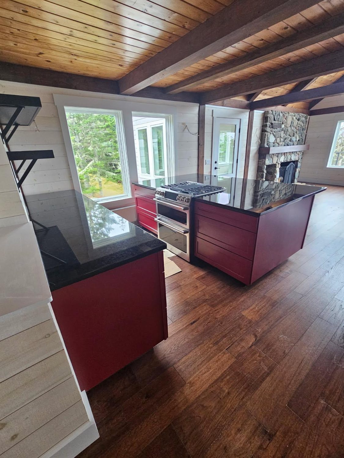 Timber-frame great room with stone fireplace built by L.E. Nichols & Son LLC — Harrington, ME
